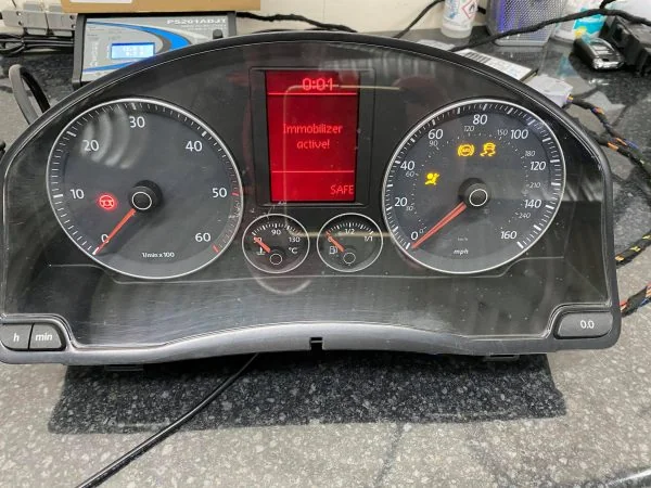 Golf MK5 diesel Highline cluster on a workshop bench showing Immobilizer active