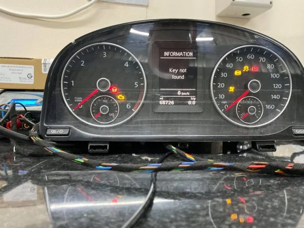 VW Caddy Highline instrument cluster on a workshop bench showing Key not found on the white display
