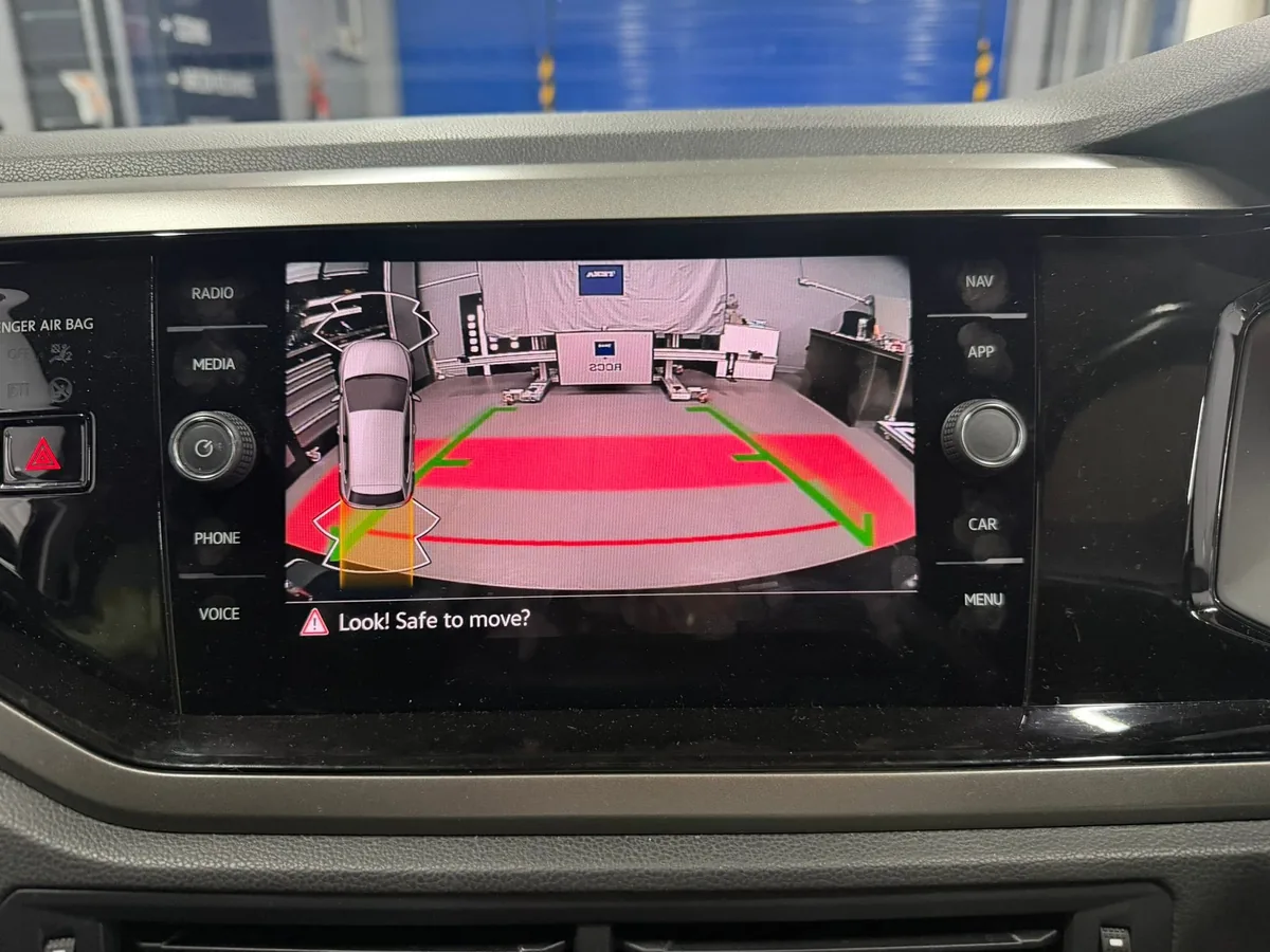 VW Polo AW reverse camera display with static guide lines and parking sensor overlay