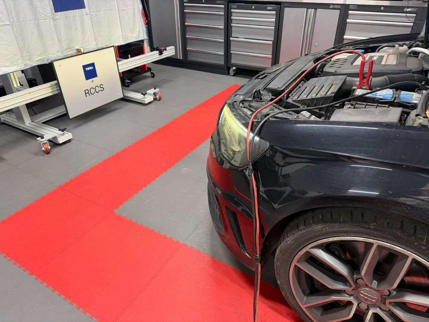 Audi in the VW Retrofit workshop beside radar calibration equipment