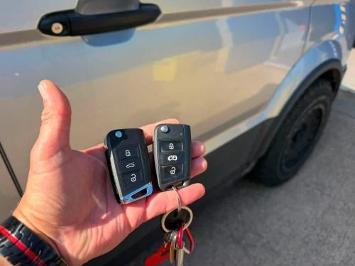 Two Volkswagen remote keys held beside a VW Crafter